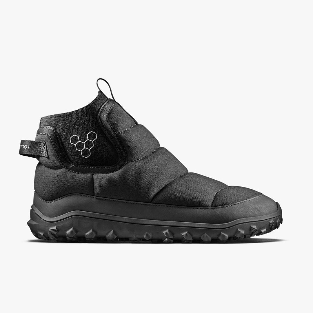 Vivobarefoot Explorer Mid Womens Obsidan-sko set fra siden, viser sorte, quiltede detaljer og tekstureret sål. Højtop silhuet med minimalistisk design til barfodet oplevelse.