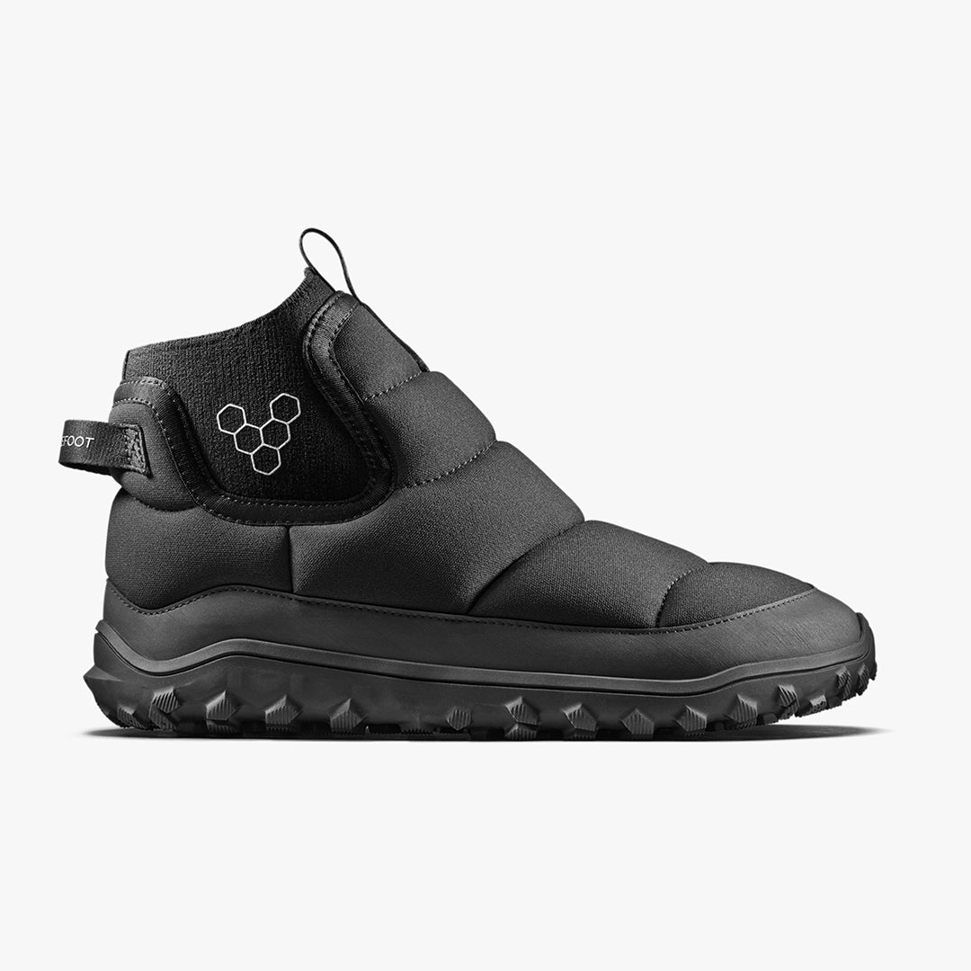 Vivobarefoot Explorer Mid Womens Obsidan-sko set fra siden, viser sorte, quiltede detaljer og tekstureret sål. Højtop silhuet med minimalistisk design til barfodet oplevelse.