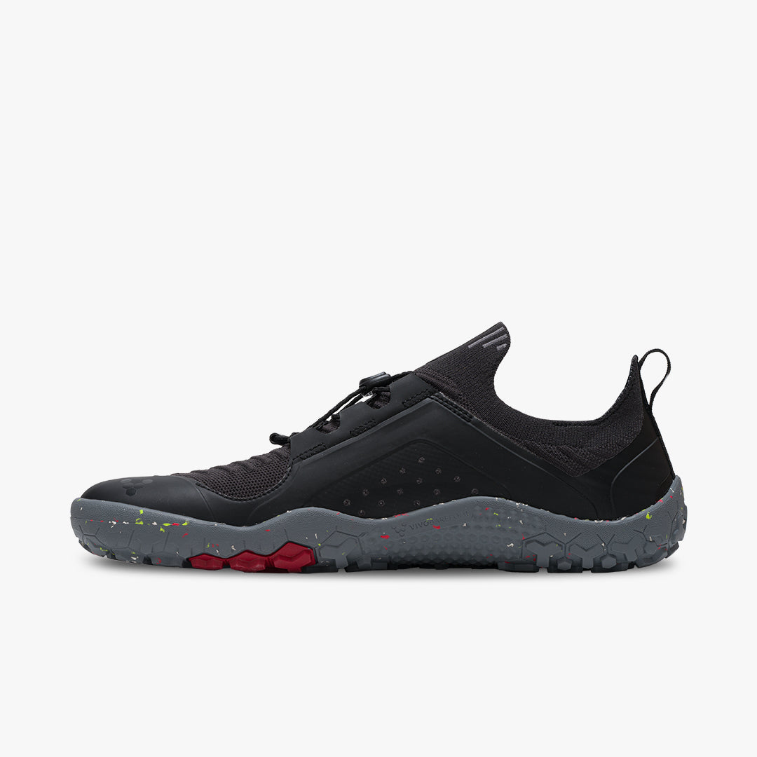 Vivobarefoot Primus Trail Knit FG herresko i Obsidian/Grey. Skoen er vegansk og fremstillet af bæredygtige materialer med åndbar mesh-øvre og solid greb-ydersål.